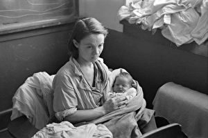 MISSOURI: REFUGEES, 1937. A mother and child, flood refugees in the schoolhouse at Sikeston MISSOURI: REFUGEES, 1937. A mother and child, flood refugees in the schoolhouse at Sikeston