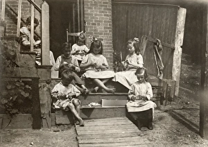 A mother with her six children working on garment tags on a tenement stoop in Roxbury A mother with her six children working on garment tags on a tenement stoop in Roxbury