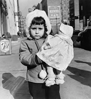 NEW YORK: MOTT STREET. Child with a doll on Mott Street, New York City NEW YORK: MOTT STREET. Child with a doll on Mott Street, New York City