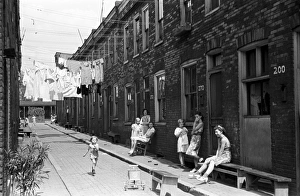 ROW HOUSE, 1938. Women and children in front of a row of low-income houses in Ambridge ROW HOUSE, 1938. Women and children in front of a row of low-income houses in Ambridge