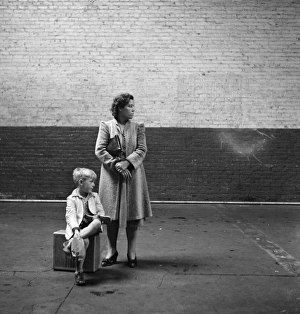 WAITING FOR BUS, 1943. Woman and child waiting for bus, United States WAITING FOR BUS, 1943. Woman and child waiting for bus, United States